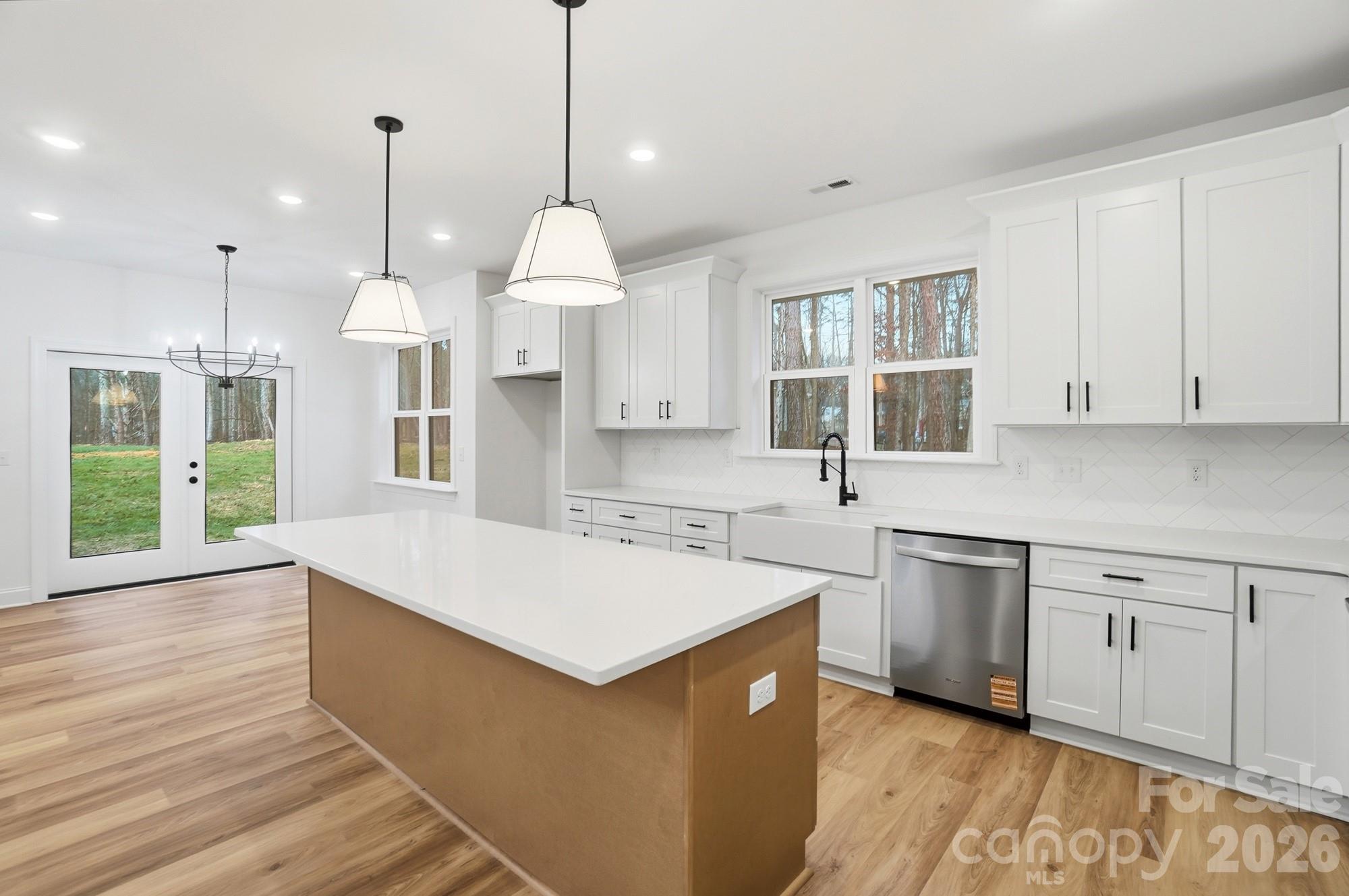 240 Hephzibah Church Road Crouse, NC 28033 - Photo 19 of 48 a large kitchen with kitchen island a sink a center island and wooden floor
