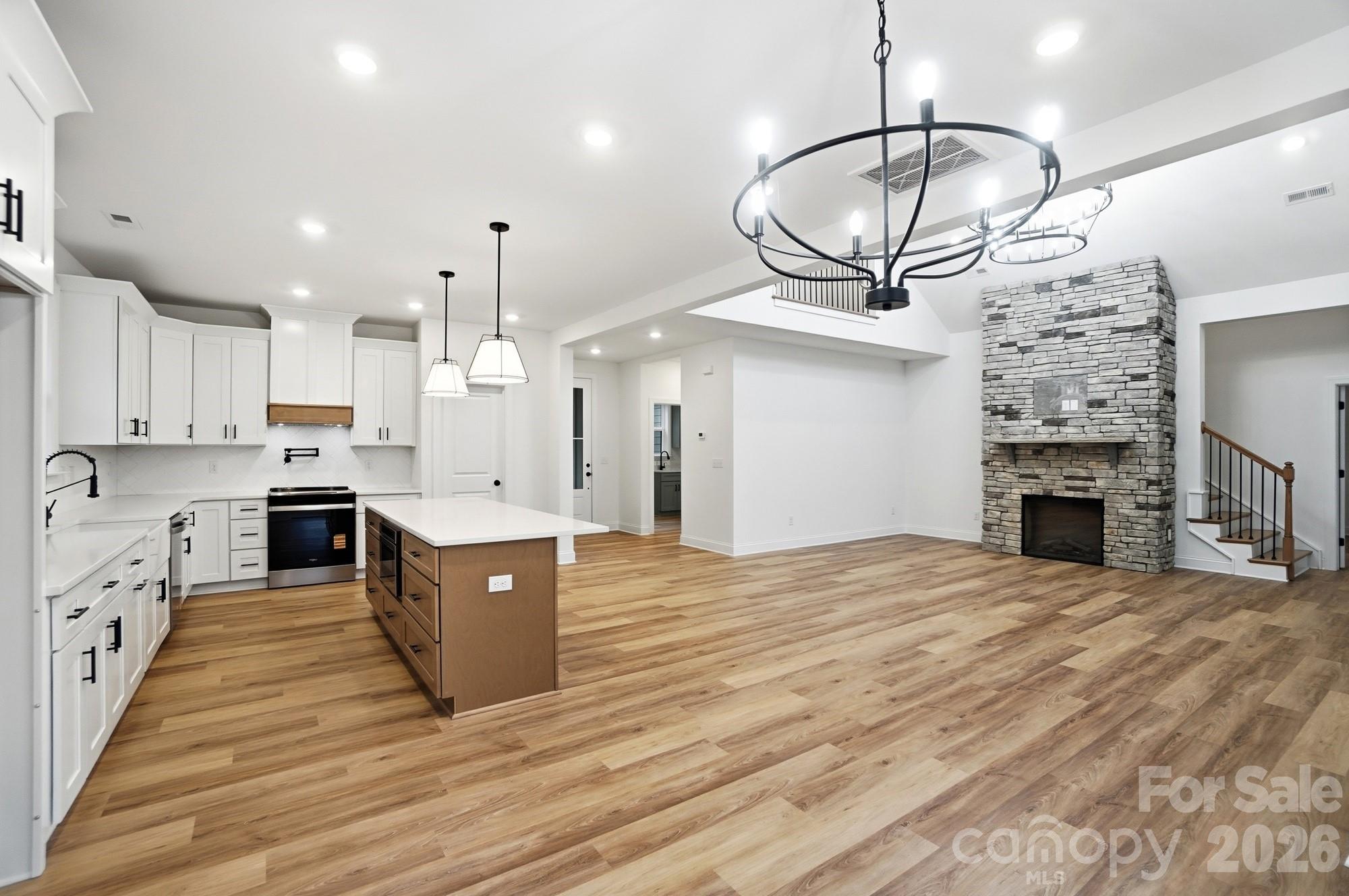 240 Hephzibah Church Road Crouse, NC 28033 - Photo 21 of 48 a kitchen with stainless steel appliances granite countertop a refrigerator a stove and a wooden floors