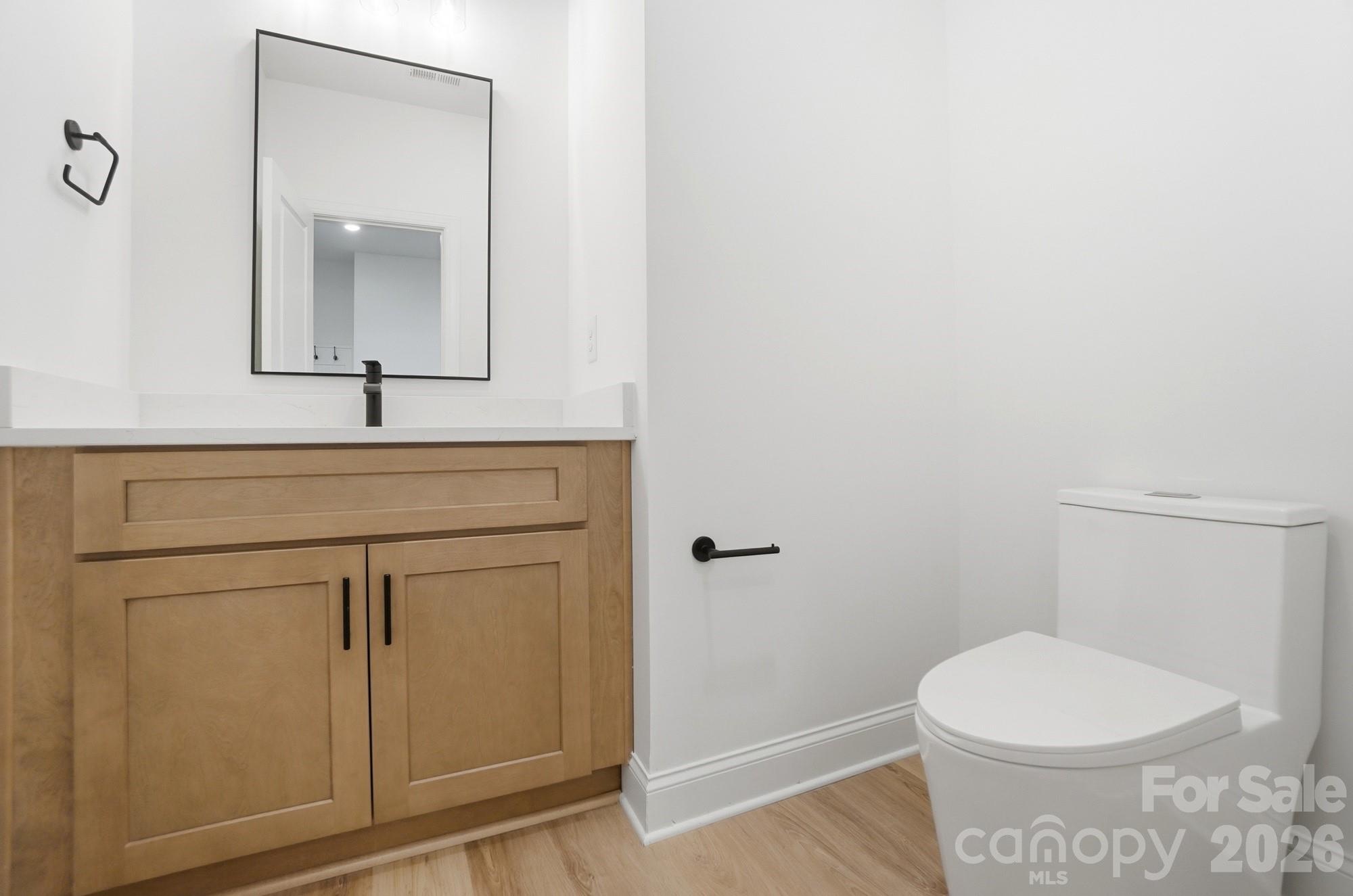 240 Hephzibah Church Road Crouse, NC 28033 - Photo 24 of 48 a bathroom with a toilet a sink a vanity and mirror