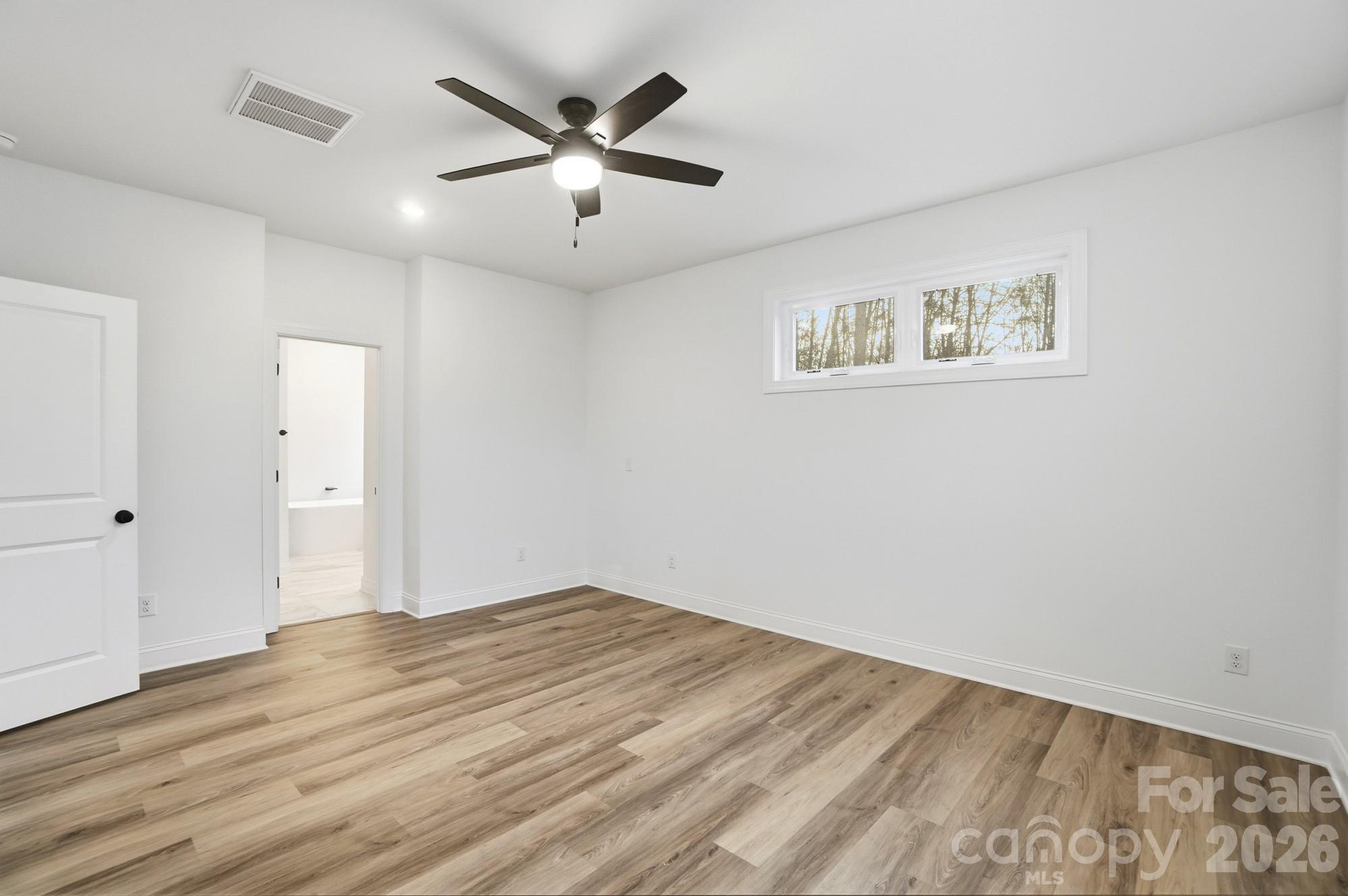 240 Hephzibah Church Road Crouse, NC 28033 - Photo 26 of 48 an empty room with wooden floor and windows