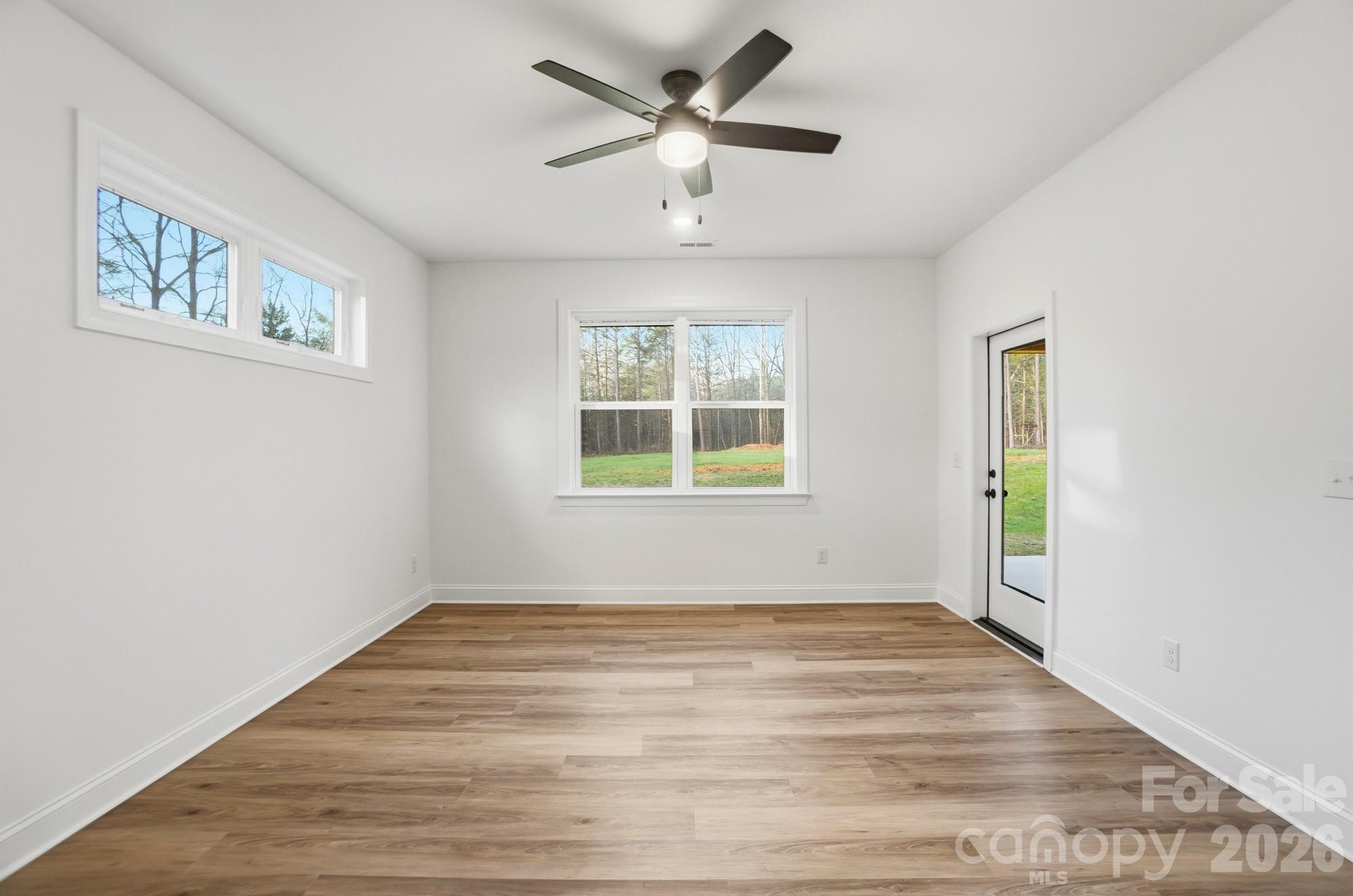 240 Hephzibah Church Road Crouse, NC 28033 - Photo 27 of 48 a view of empty room with wooden floor and fan