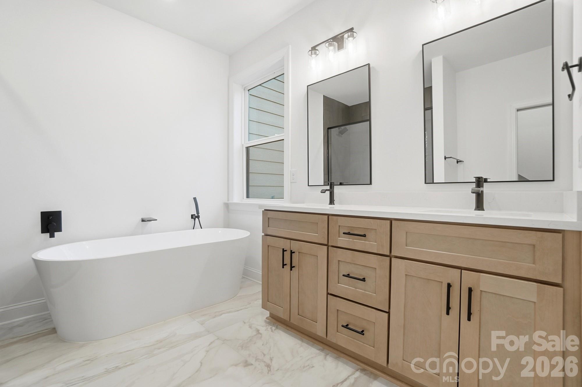 240 Hephzibah Church Road Crouse, NC 28033 - Photo 28 of 48 a bathroom with a double vanity sink mirror and bathtub