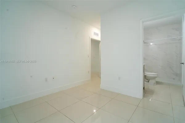 a kitchen with a refrigerator sink and cabinets