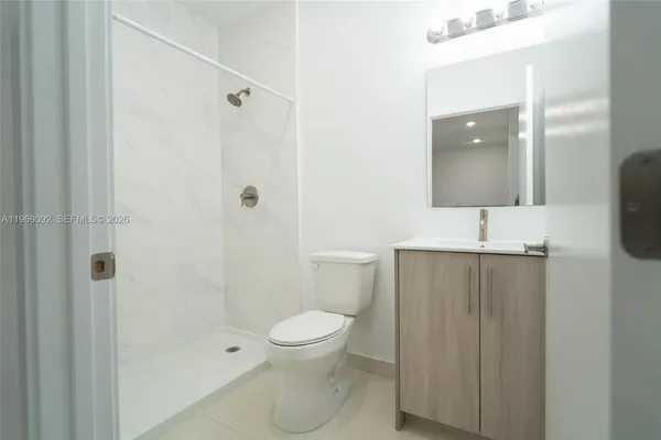 a bathroom with a toilet sink and shower