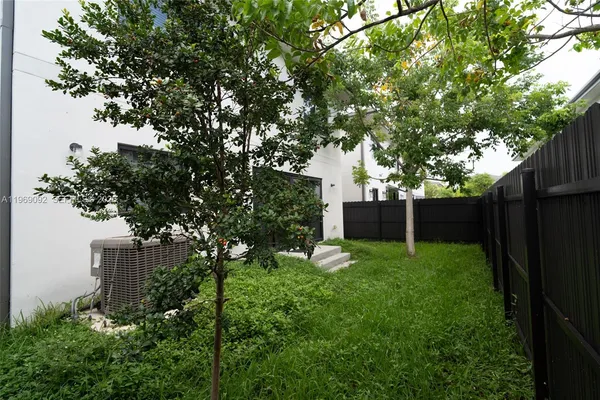 a view of a backyard with a tree
