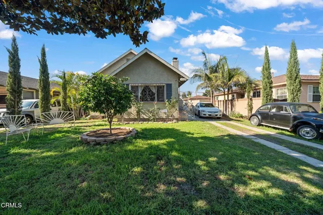 a view of a house with swimming pool and sitting area