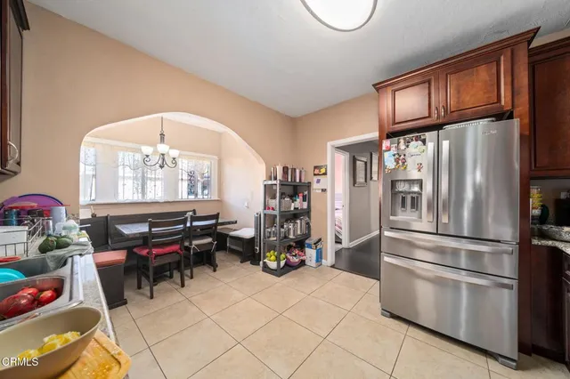 a kitchen with furniture a refrigerator and a more cabinets