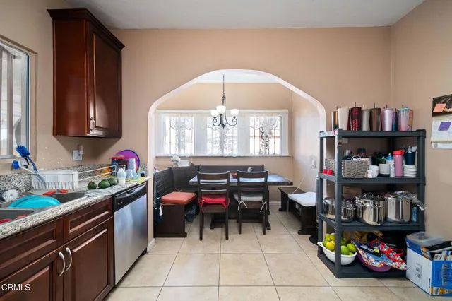 a living room with furniture and a book shelf