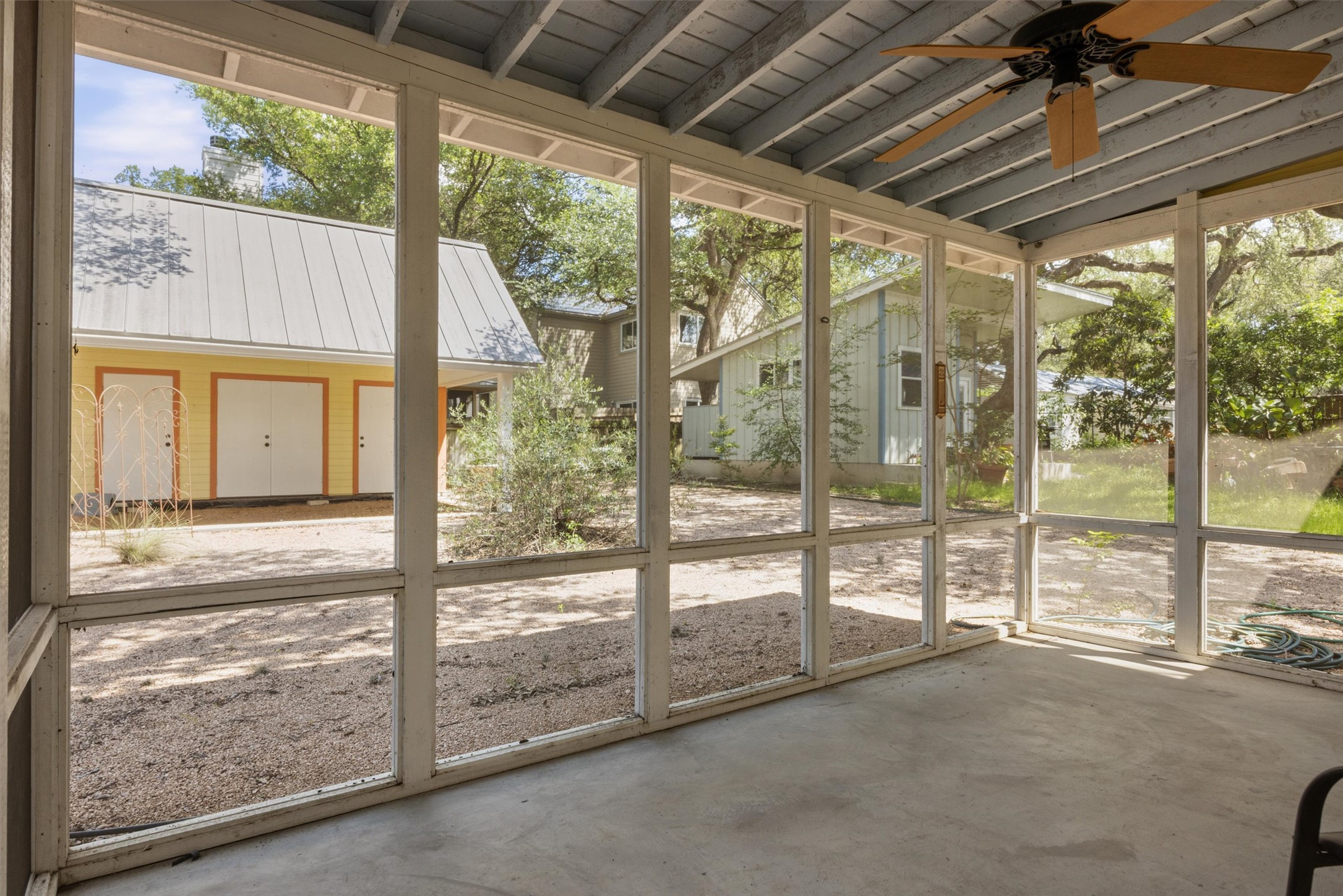 1613 Drake Avenue Austin, TX 78704 - Photo 22 of 27 Screened porch with concrete flooring and exposed beam ceiling