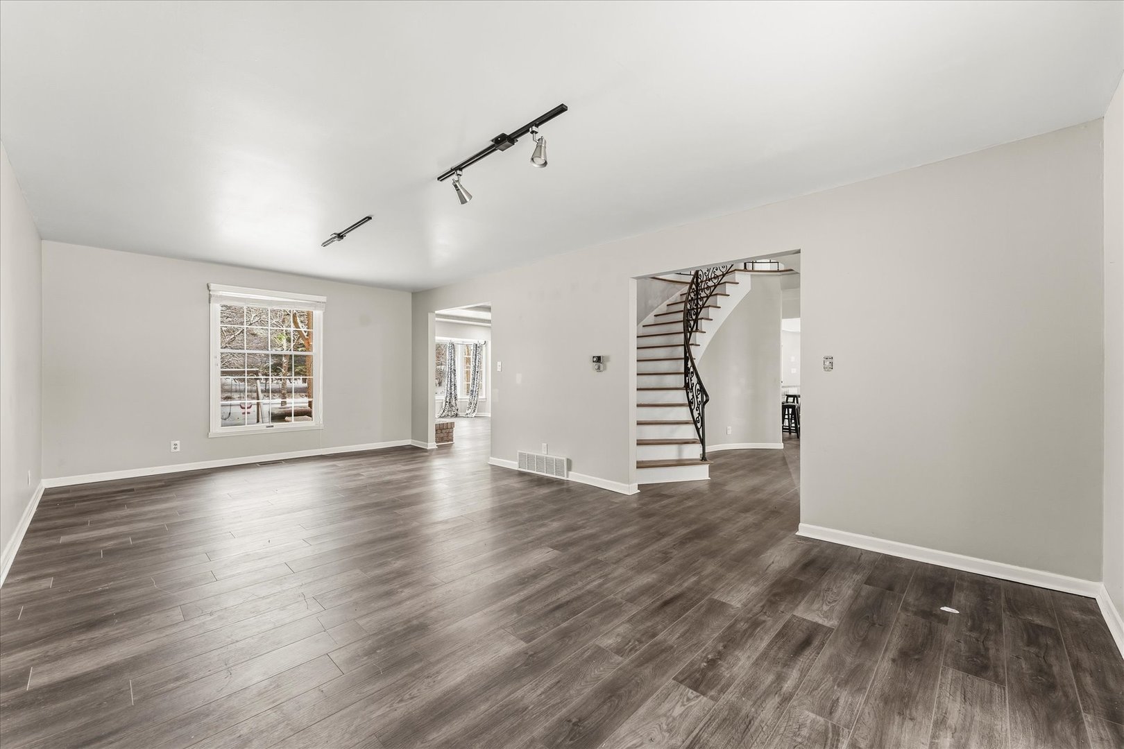142 Lake Road Seymour, IL 61875 - Photo 6 of 49 a view of an empty room with wooden floor and a window