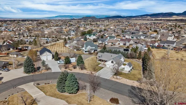 an aerial view of a house with a yard