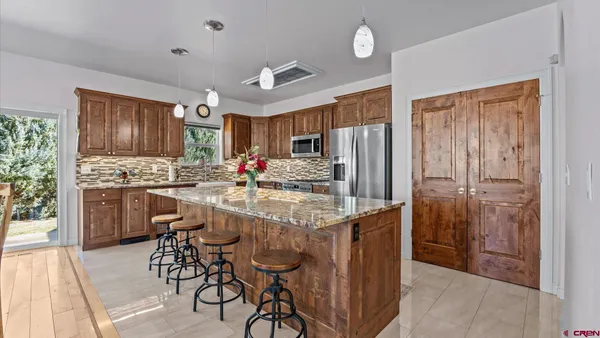 a kitchen with stainless steel appliances granite countertop a sink and cabinets