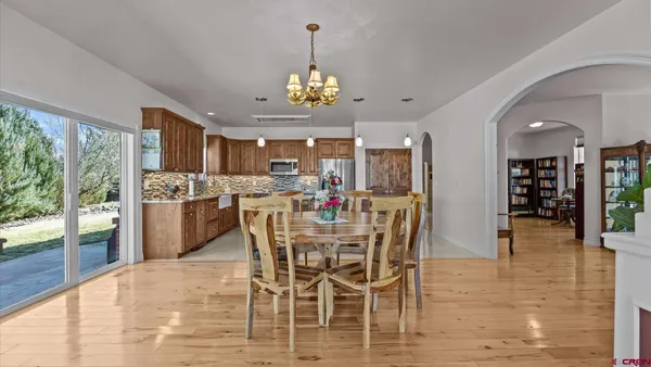 a dining room with furniture window and wooden floor