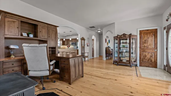 a work room with furniture and wooden floor