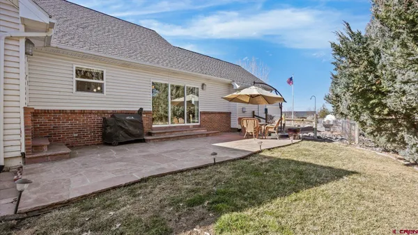 a view of a house with backyard porch and sitting area