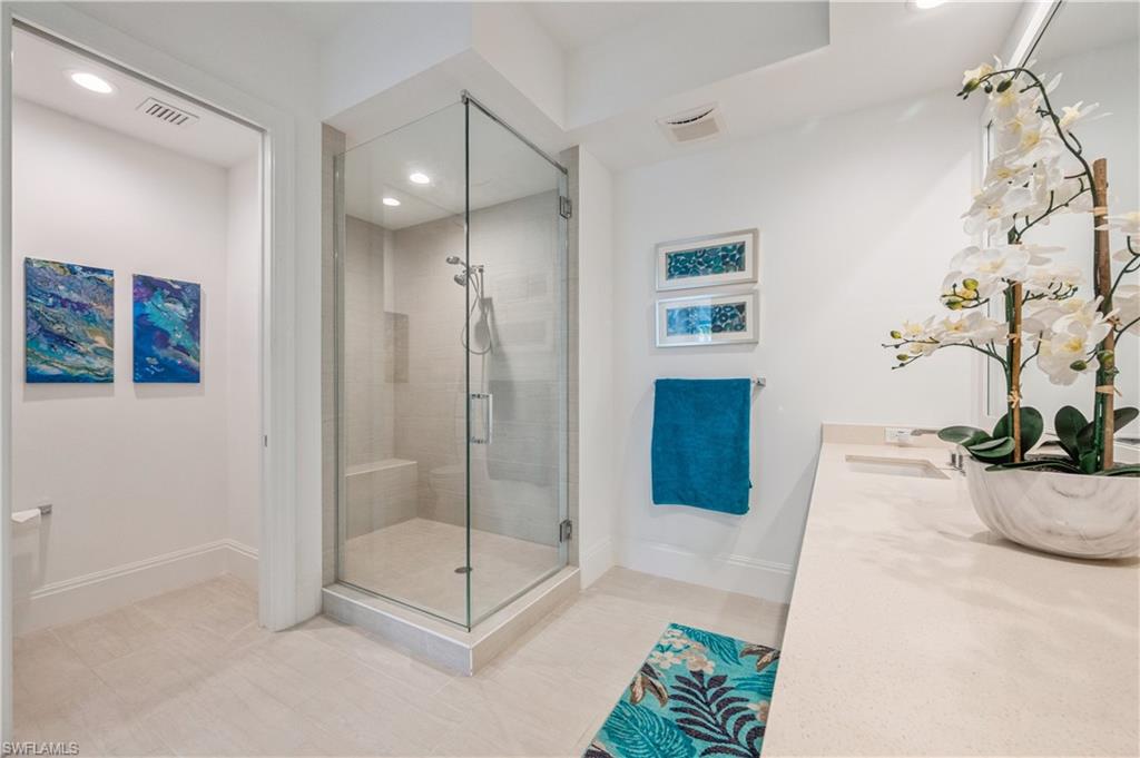 1135 3rd Avenue South, Unit 304 Naples, FL 34102 - Photo 24 of 35 Bathroom with tile patterned floors, vanity, and a shower with door