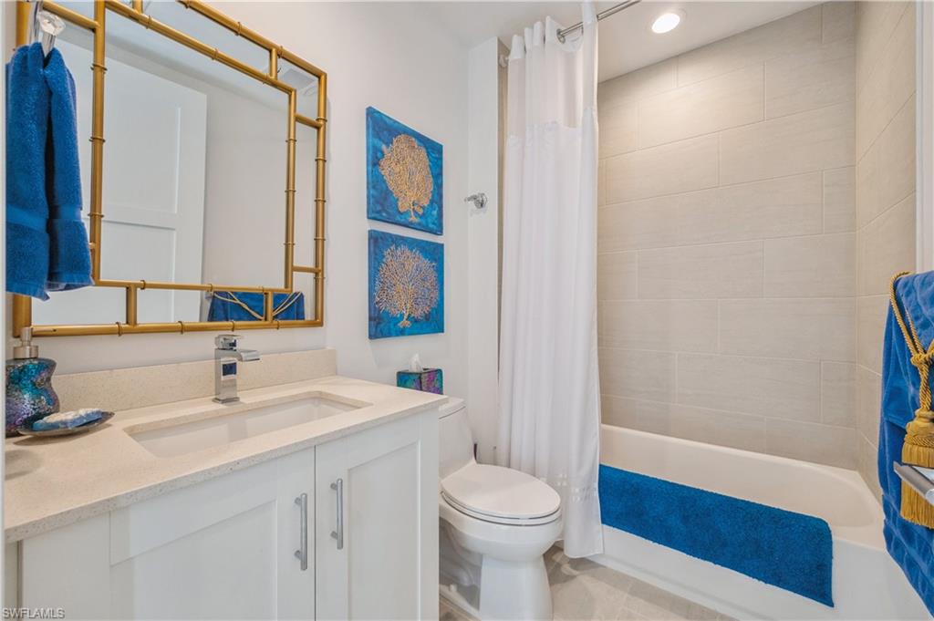 1135 3rd Avenue South, Unit 304 Naples, FL 34102 - Photo 26 of 35 Full bathroom featuring toilet, vanity, and shower / tub combo with curtain