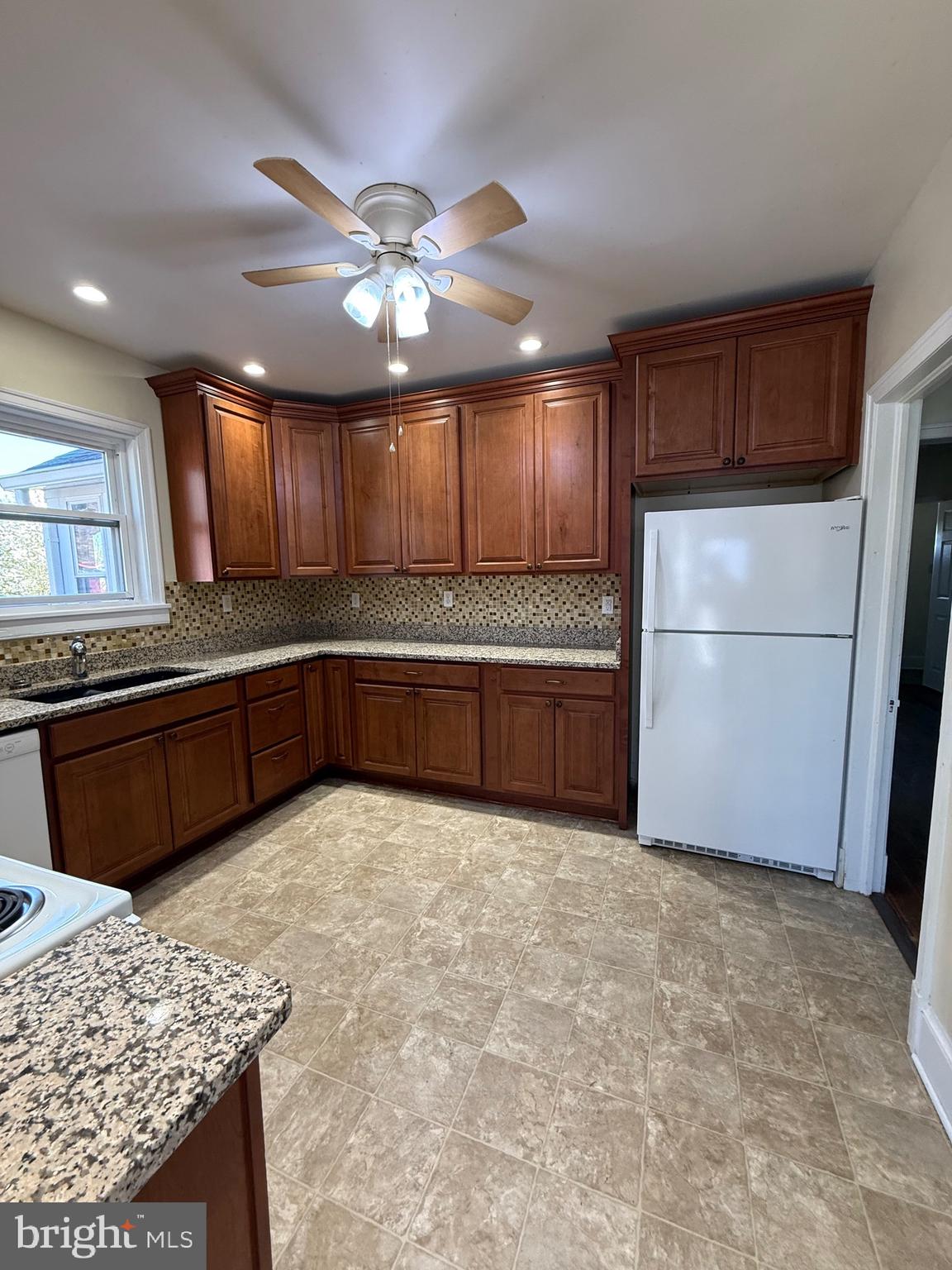9253 Dahlgren Road King George, VA 22485 - Photo 6 of 23 a kitchen with granite countertop a refrigerator and a sink