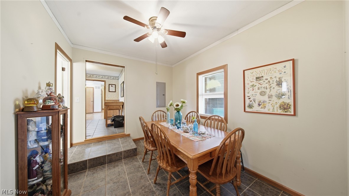 89 Dagg Road Parkersburg, WV 26101 - Photo 21 of 45 Dining area featuring a wood-finish ceiling fan with integrated lighting, a window with wood trim, and tile flooring