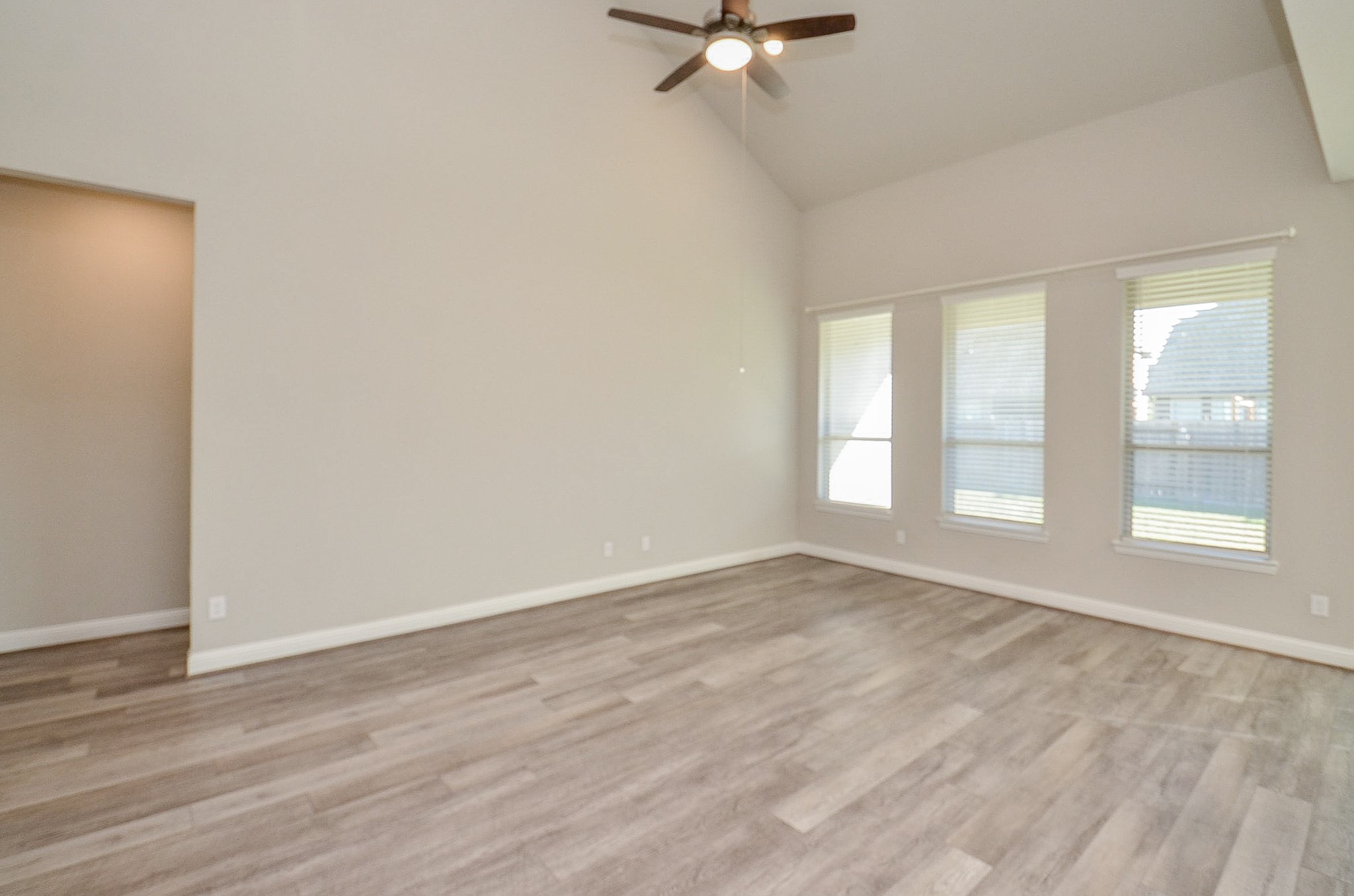 338 Summer Landing Court Rosenberg, TX 77469 - Photo 16 of 50 a view of an empty room with a window and wooden floor