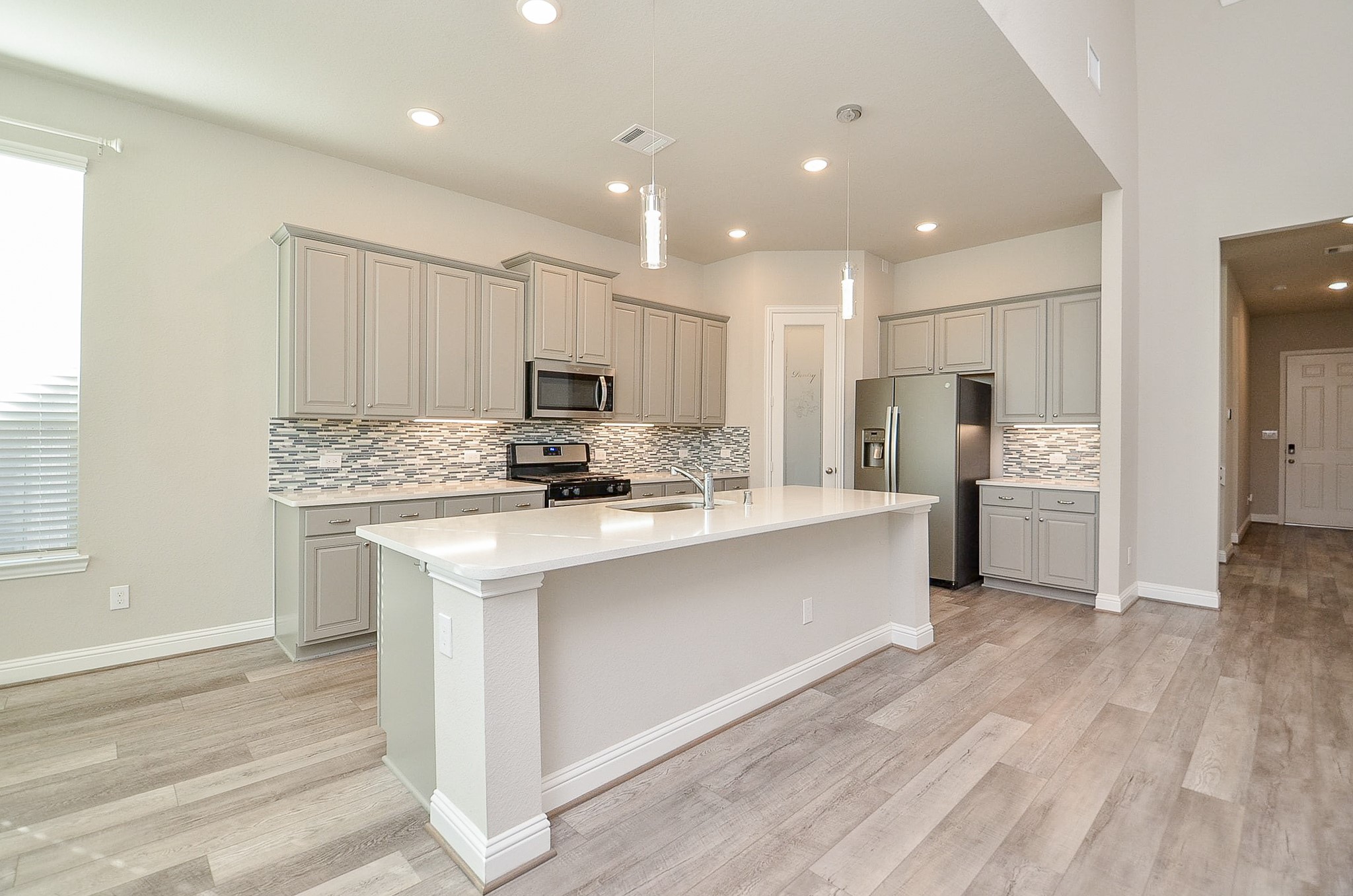 338 Summer Landing Court Rosenberg, TX 77469 - Photo 29 of 50 a kitchen with stainless steel appliances kitchen island granite countertop a refrigerator and a stove top oven