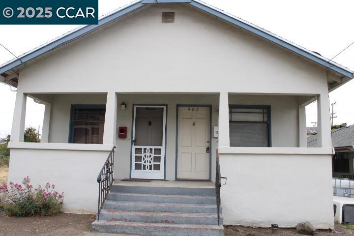 5918 Alameda Avenue, Unit 5918 Richmond, CA 94804 - Photo 1 of 16 a front view of a house with a garage