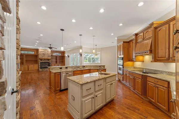 a kitchen with stainless steel appliances granite countertop a sink stove and refrigerator