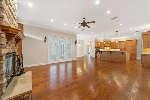 a view of empty room with wooden floor and fireplace