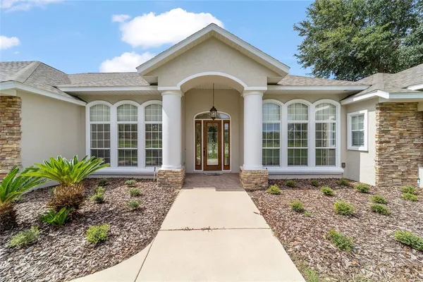 a view of a big room with wooden floor a chandelier