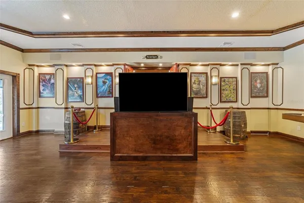 an aerial view of a house with a yard and trees all around