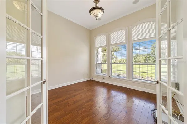 a view of a room with wooden floor and chandelier