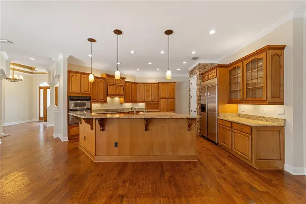a kitchen with stainless steel appliances granite countertop a sink a stove and a refrigerator