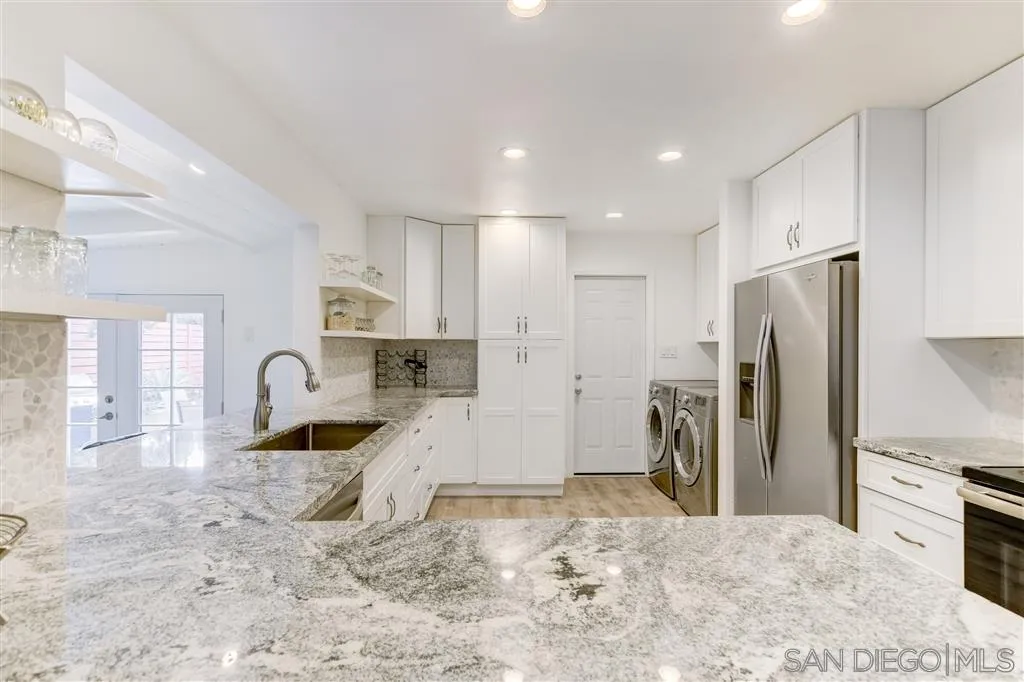 1985 La Cresta Road El Cajon, CA 92021 - Photo 12 of 25 a large kitchen with stainless steel appliances kitchen island granite countertop a refrigerator and a sink