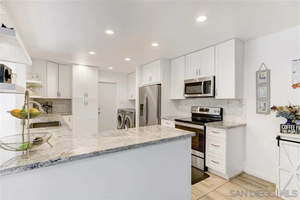 1985 La Cresta Road El Cajon, CA 92021 - Photo 13 of 25 a kitchen with granite countertop a sink a stove a refrigerator a microwave a counter top space and cabinets