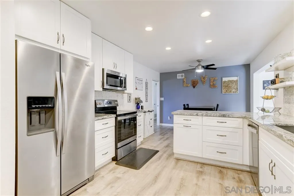 1985 La Cresta Road El Cajon, CA 92021 - Photo 14 of 25 a kitchen with white cabinets and stainless steel appliances
