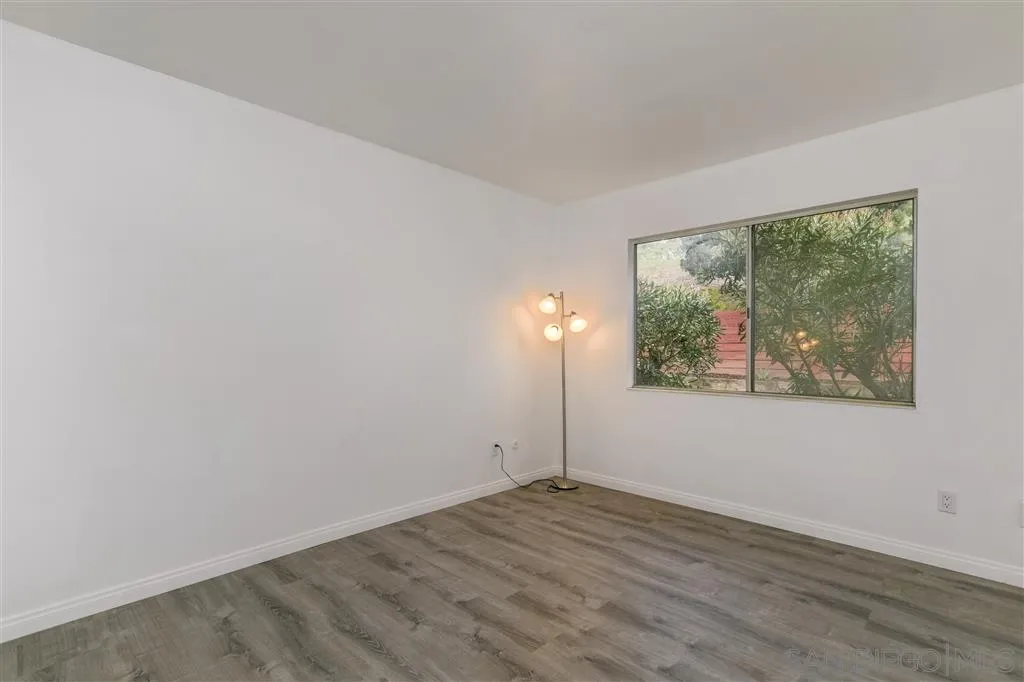 1985 La Cresta Road El Cajon, CA 92021 - Photo 18 of 25 an empty room with wooden floor and windows