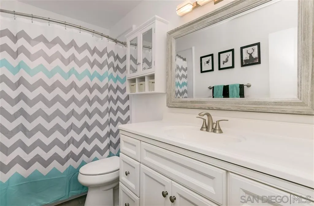 1985 La Cresta Road El Cajon, CA 92021 - Photo 20 of 25 a bathroom with a sink toilet and mirror