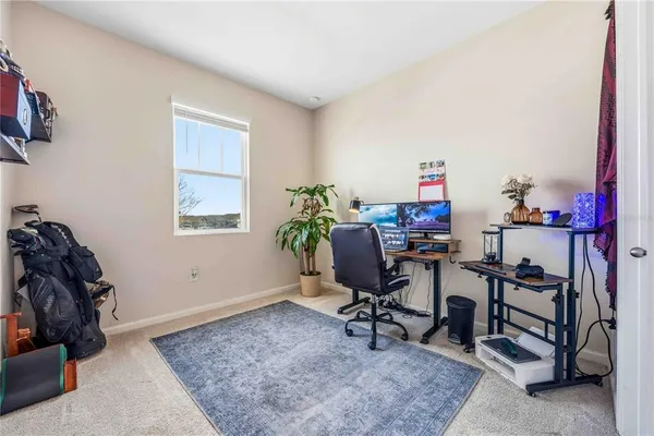 a view of a workspace with furniture and a window