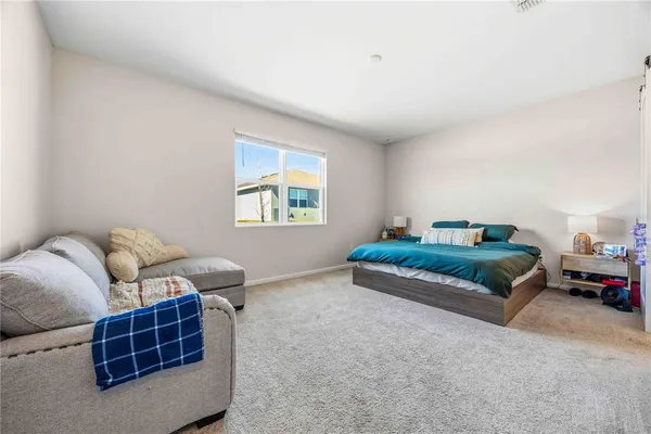 a bedroom with furniture and a window