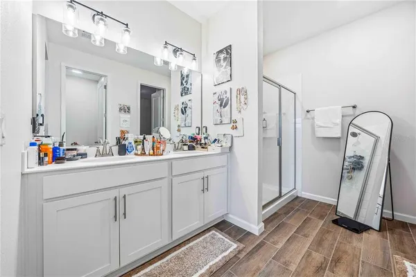 a bathroom with a sink a mirror and a shower