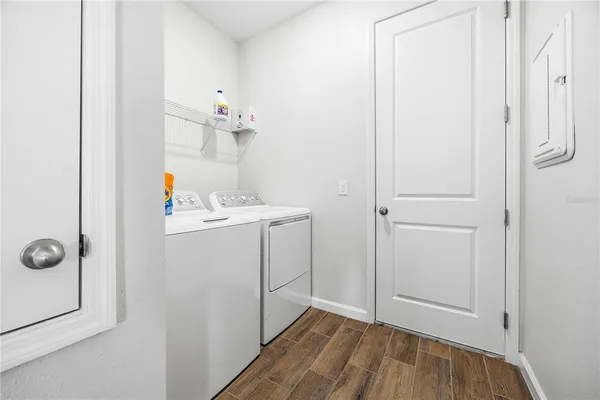 a utility room with cabinets washer and dryer