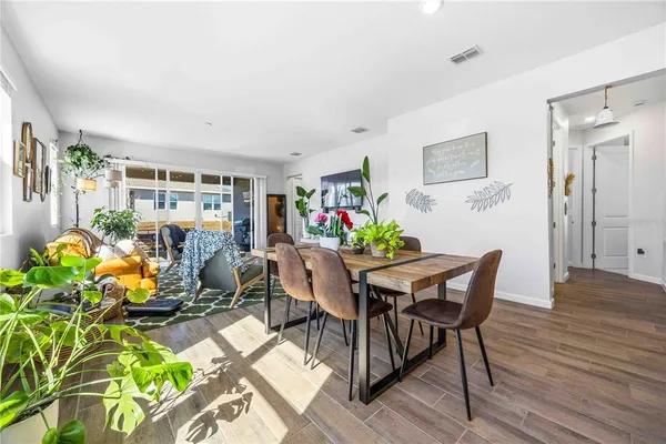 a view of a dining room with furniture and a potted plant