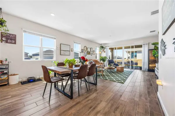 a view of a dining room with furniture and wooden floor