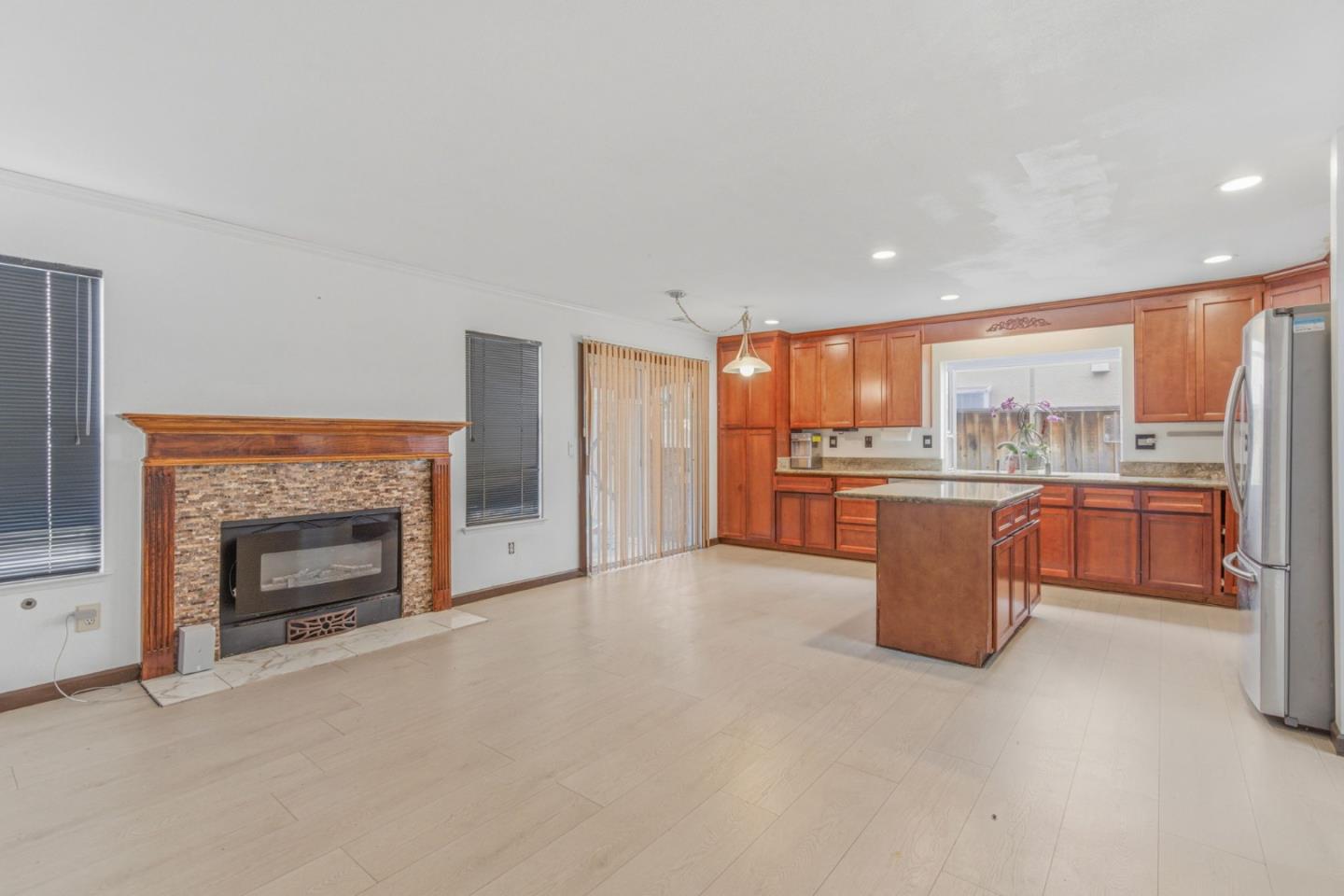 2678 Ramsdell Place San Jose, CA 95148 - Photo 14 of 41 a open kitchen with a refrigerator a stove top oven and kitchen island