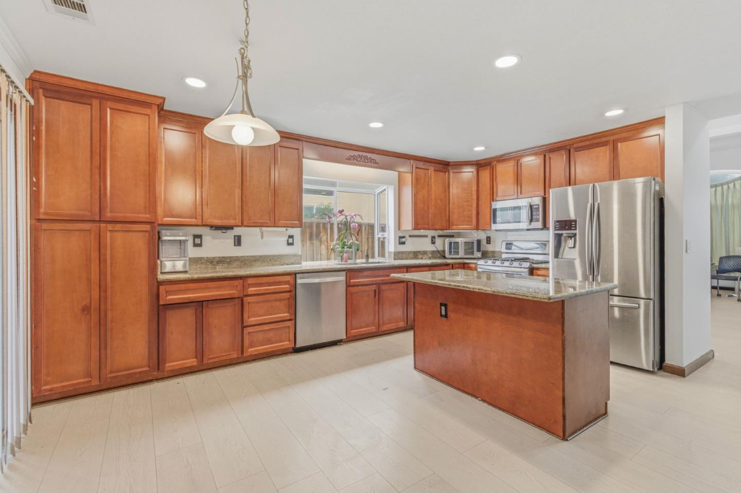 2678 Ramsdell Place San Jose, CA 95148 - Photo 19 of 41 a kitchen with stainless steel appliances granite countertop a refrigerator sink and cabinets