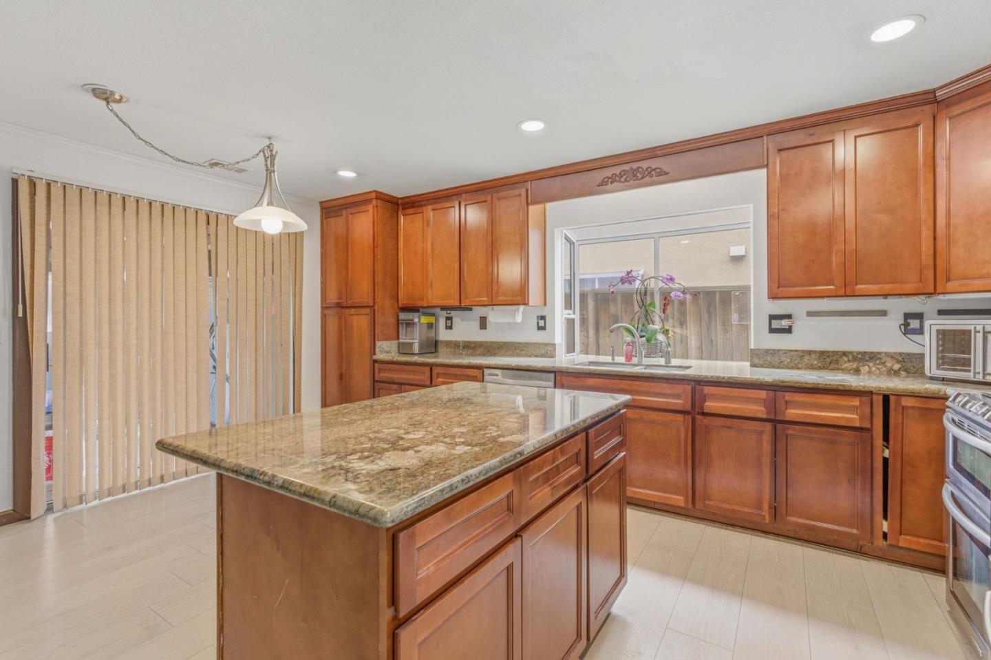 2678 Ramsdell Place San Jose, CA 95148 - Photo 23 of 41 a kitchen with stainless steel appliances granite countertop wooden cabinets a sink and a large window