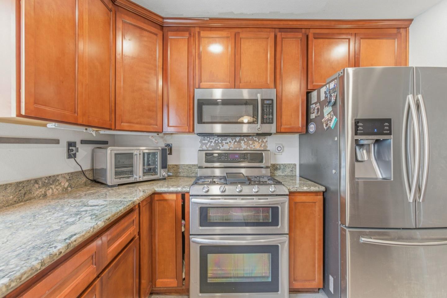 2678 Ramsdell Place San Jose, CA 95148 - Photo 24 of 41 a kitchen with granite countertop a refrigerator and a sink