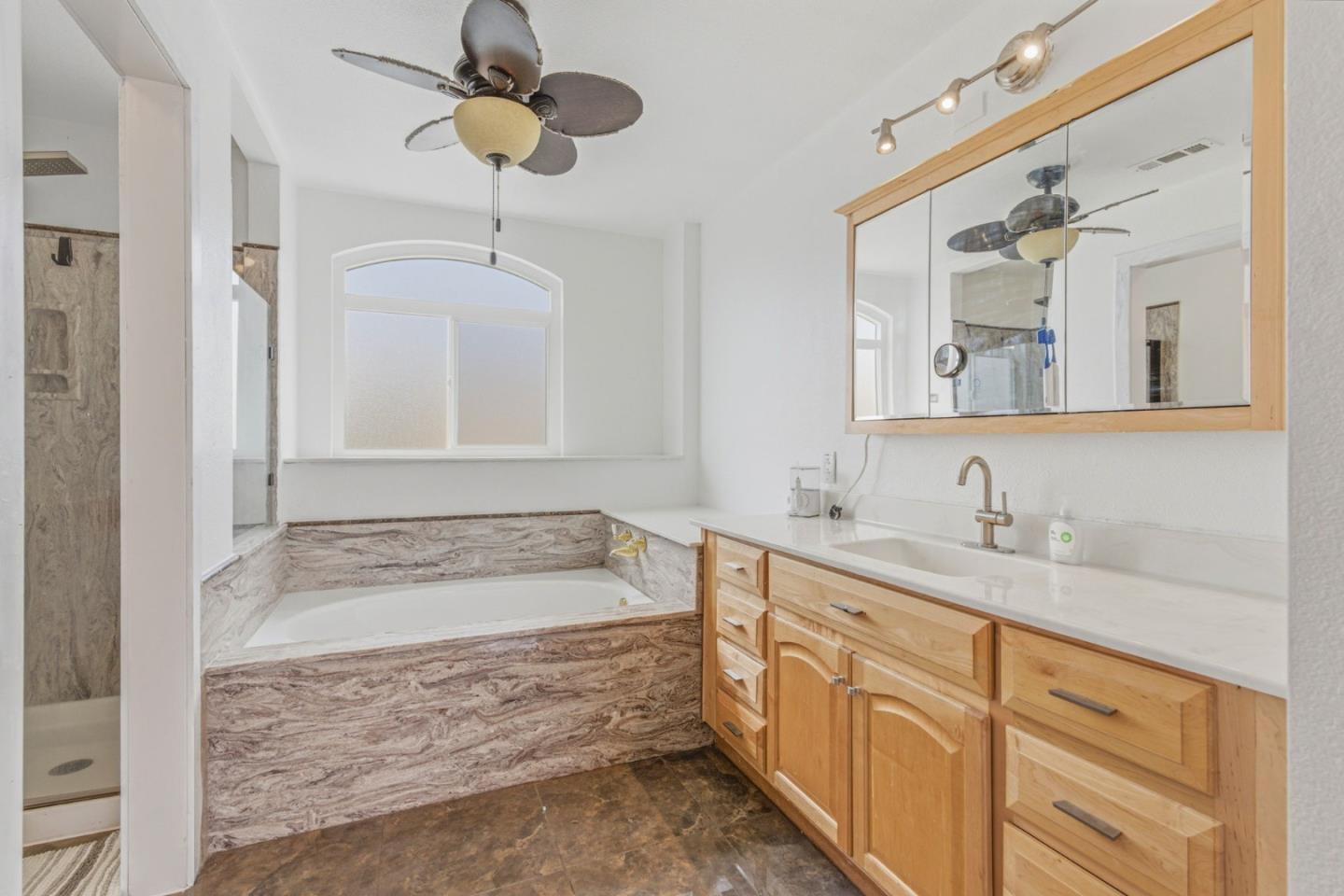 2678 Ramsdell Place San Jose, CA 95148 - Photo 35 of 41 a bathroom with a granite countertop sink a bathtub a mirror and vanity