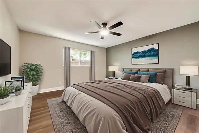 a spacious bedroom with a large bed and a chandelier