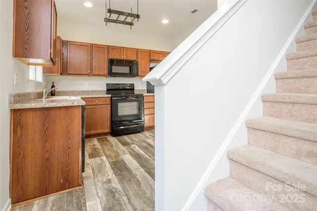 a view of kitchen with microwave and cabinets